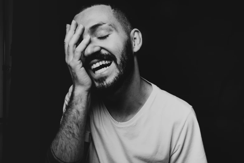 a black and white image of a bearded man