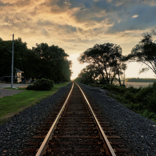 a train track stretches along the edge of some water