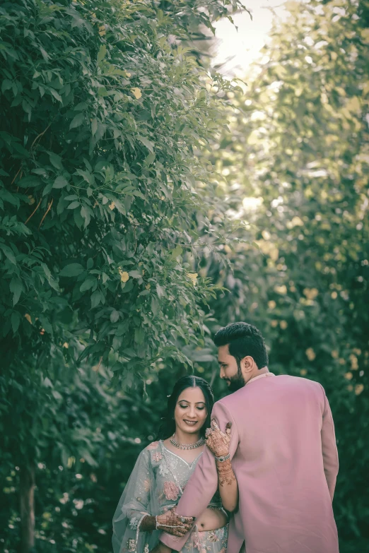 an indian couple is smiling and emcing with their arms around each other