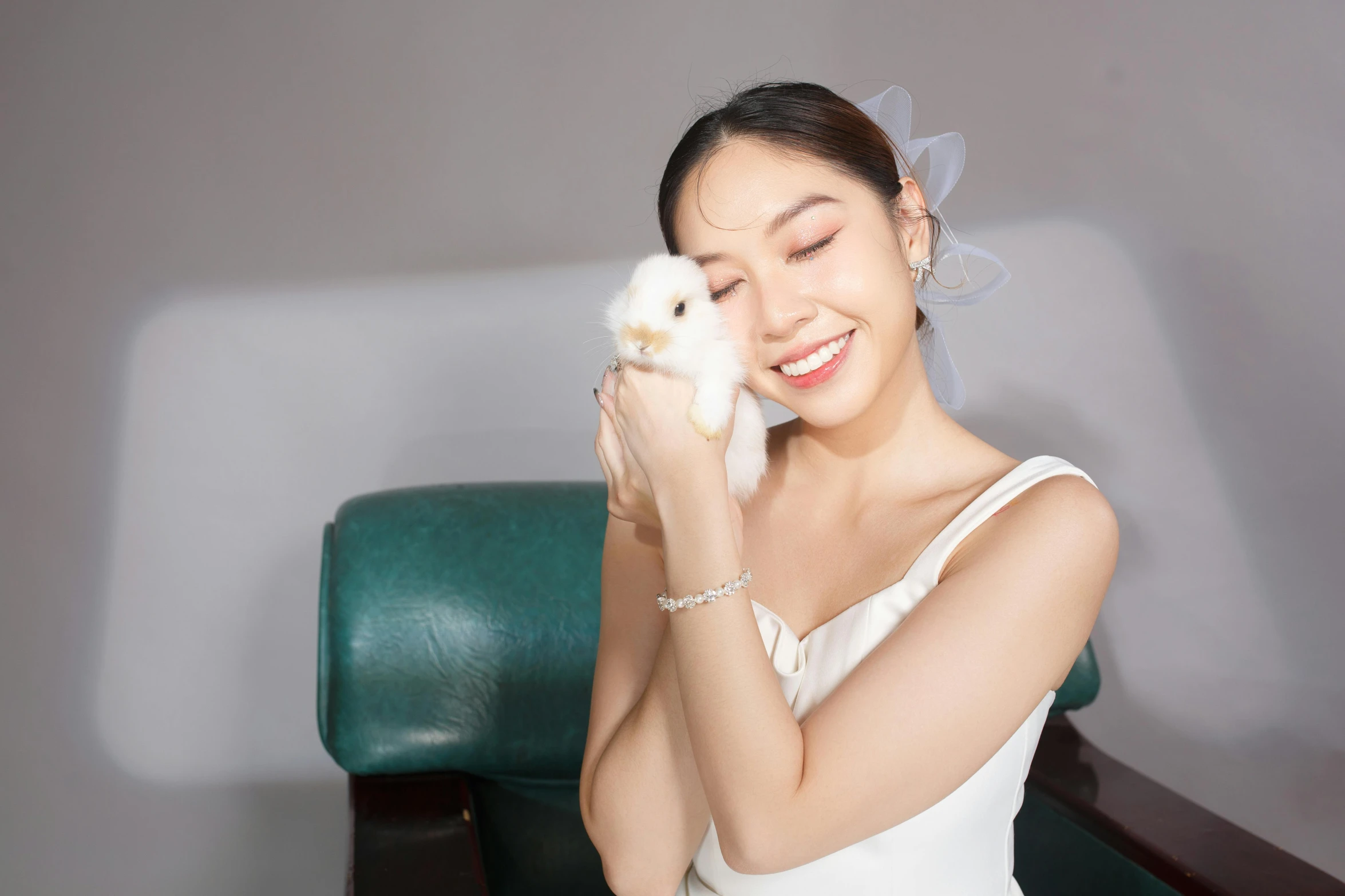 a bride holding a small white and orange kitten