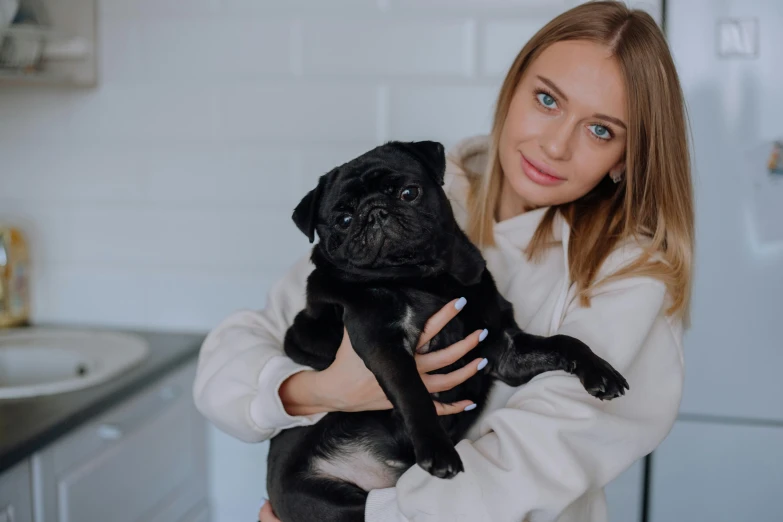 a person holding a small dog in their arms