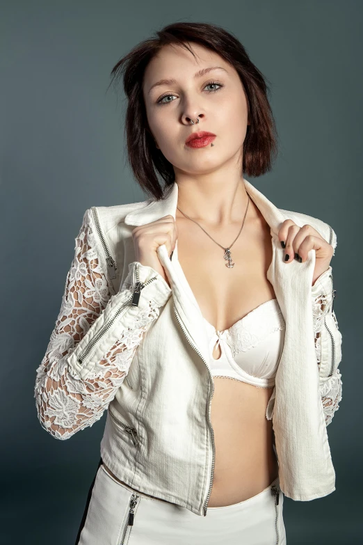 a woman in a white jacket poses for a picture