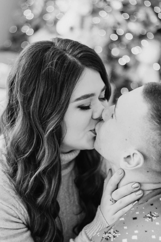 a woman kisses the cheek of a man