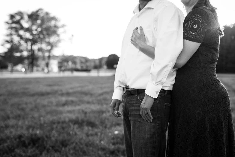 an older couple emcing in the middle of a field