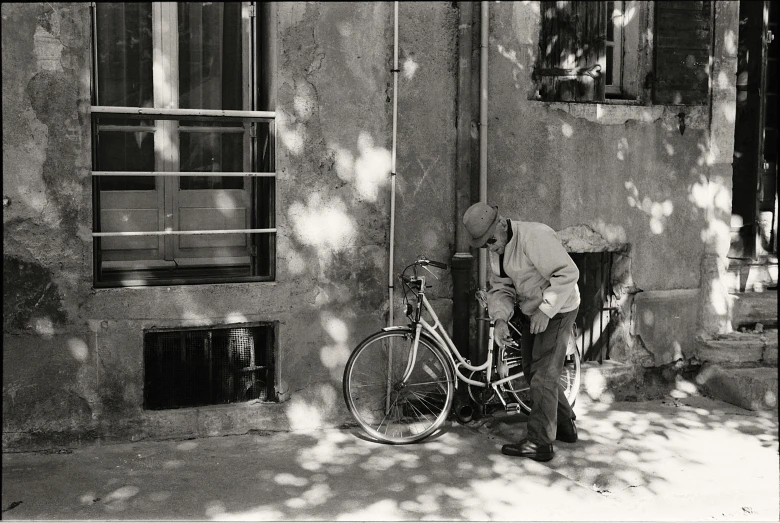 a man fixing a bike on the street