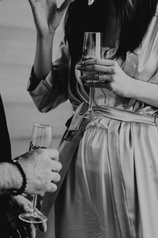 a woman is drinking wine while another woman drinks out of the glass