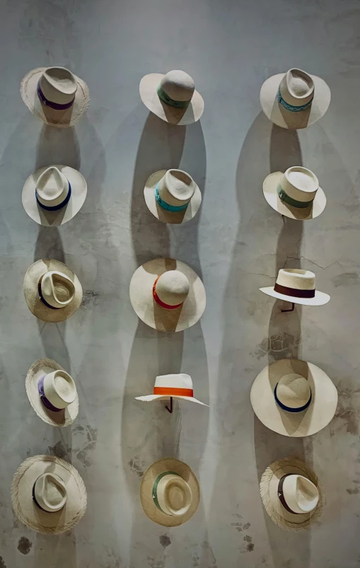 hats sit on a wall in rows and are lined up