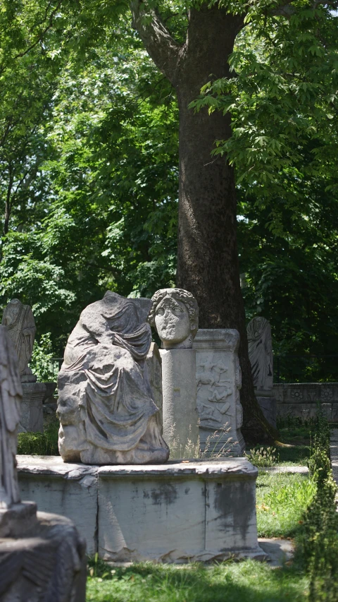 many statues on the ground in a graveyard