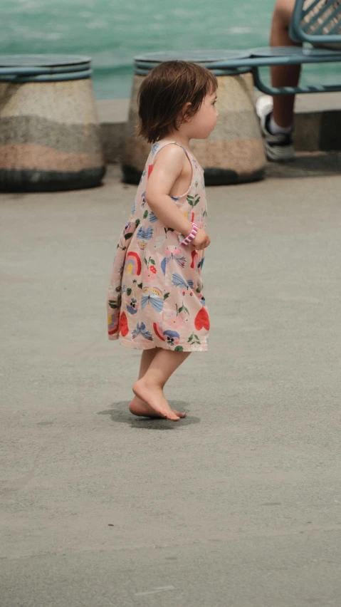 a little girl that is standing up in the street