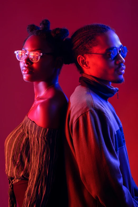 a man and woman wearing protective glasses are posed in a studio