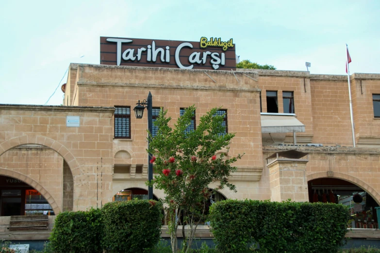 the exterior of a cafe building with tall bricked buildings