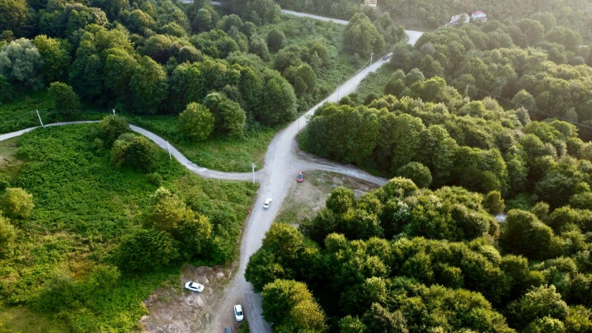 an overhead view of the road in a forested area