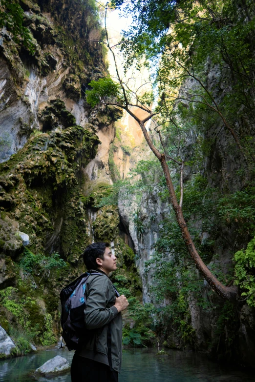 the man stands on rocks while looking at soing