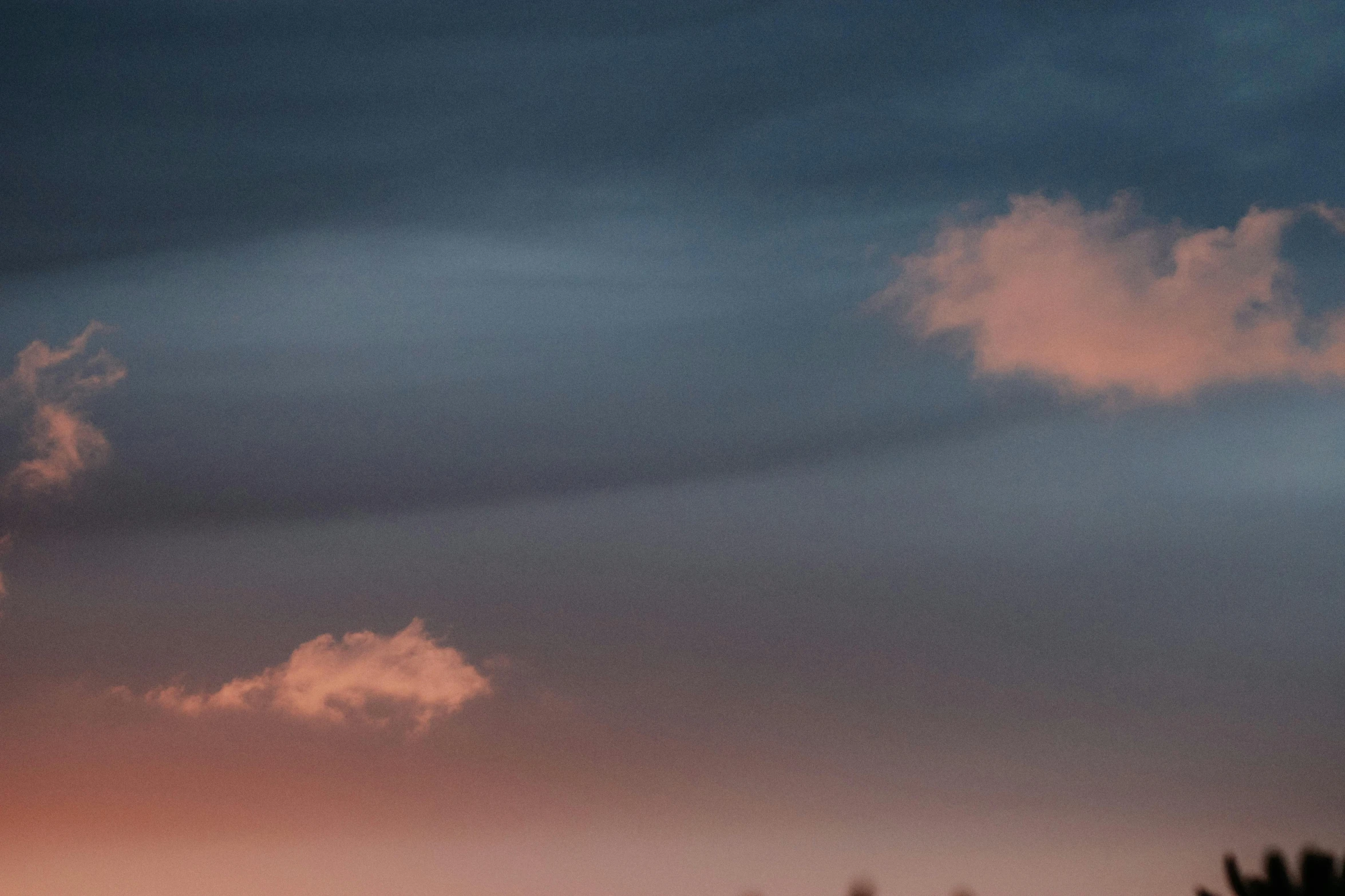 a plane flying over a cloud covered sky