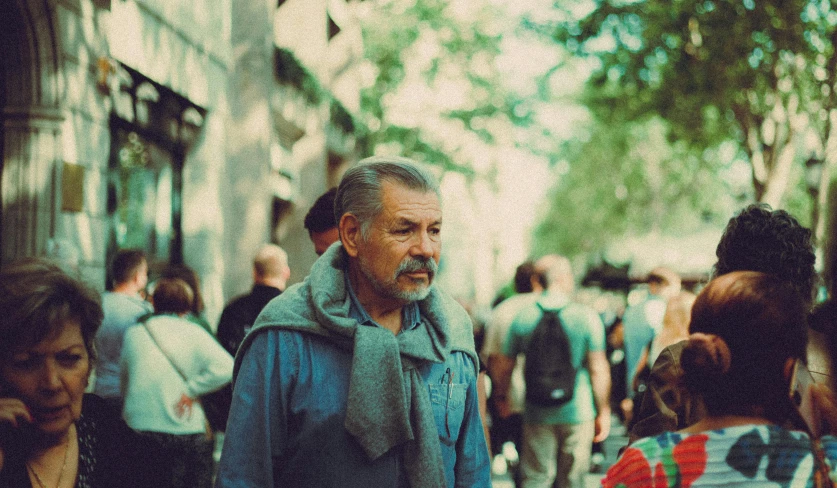 a man standing on a busy city sidewalk