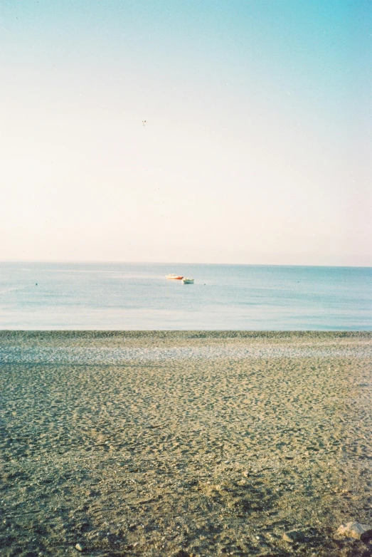 a boat is sitting in the distance by the water