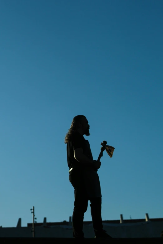 a man holding an acoustic guitar in his hand