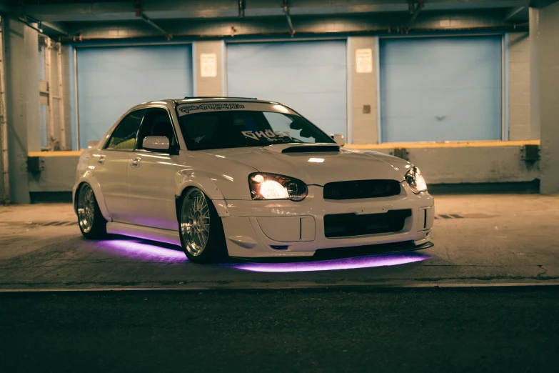 a white sports car with glowing bumper stickers