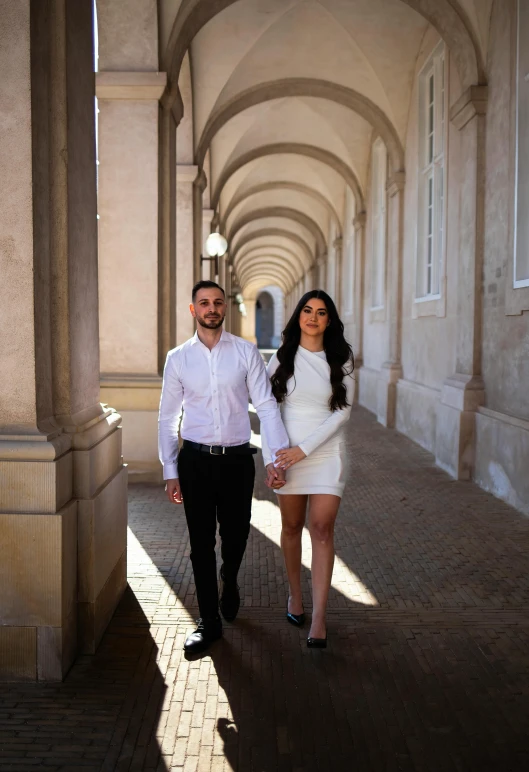 two people walking on a walkway holding hands