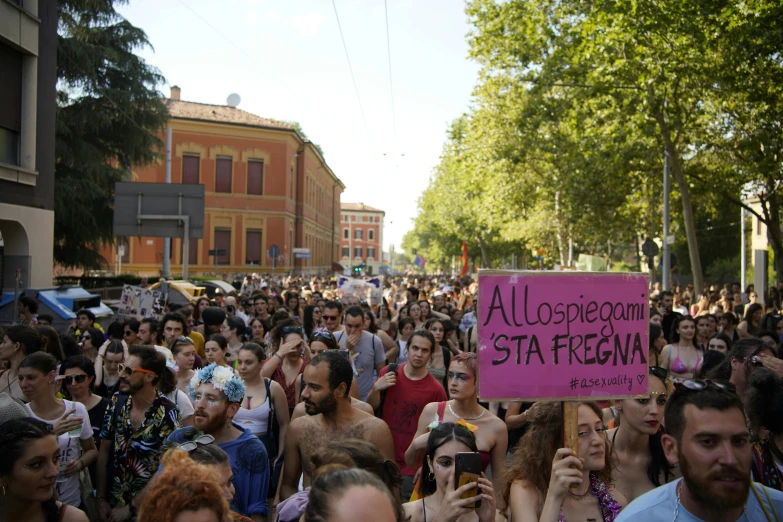 a group of people in the street holding signs