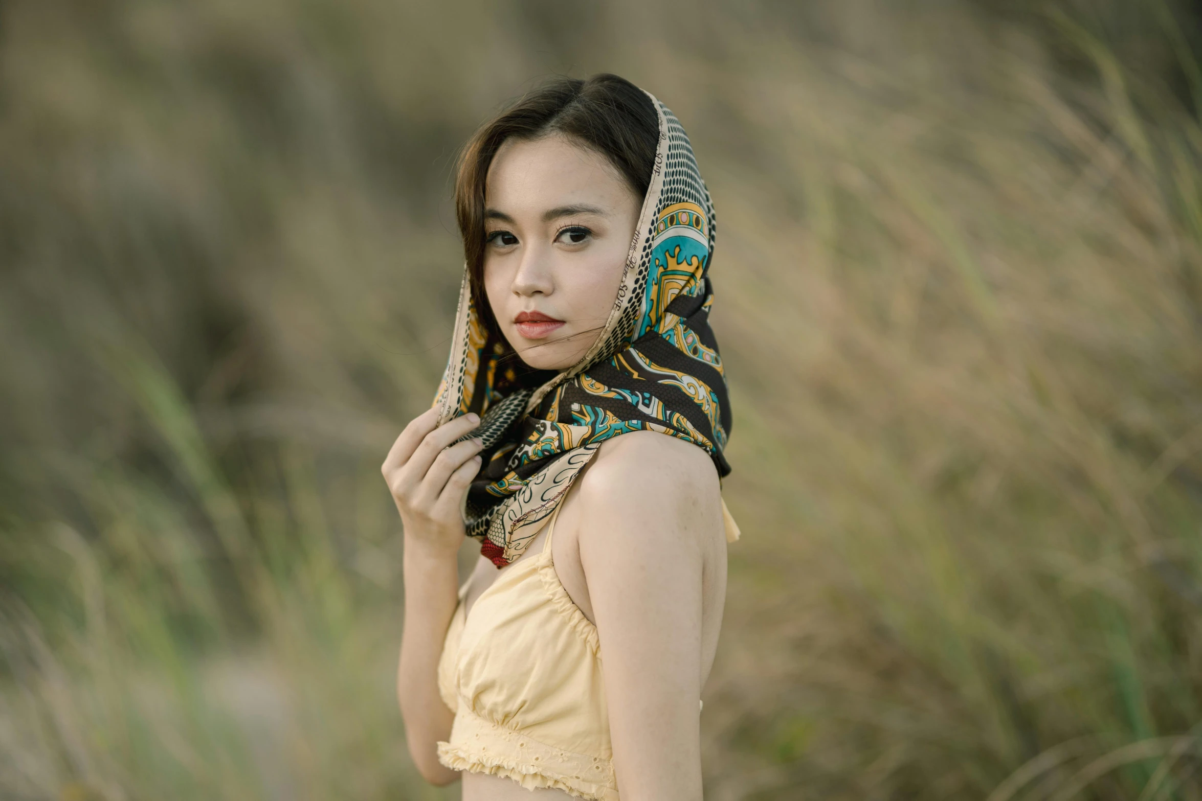 woman in a scarf poses for a po