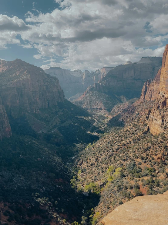 mountains with trees and cliffs with sky above them