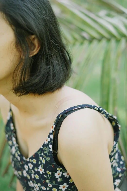 a woman wearing a flowered top with a frecky neck