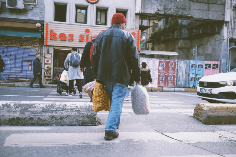 a man is walking on the street with luggage