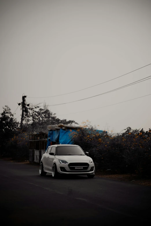 a white car parked at a rural roadside