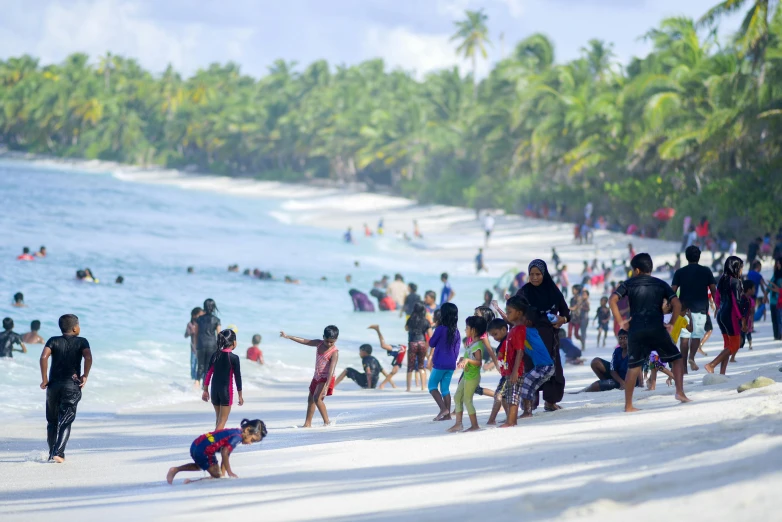 people are on the sand at the beach