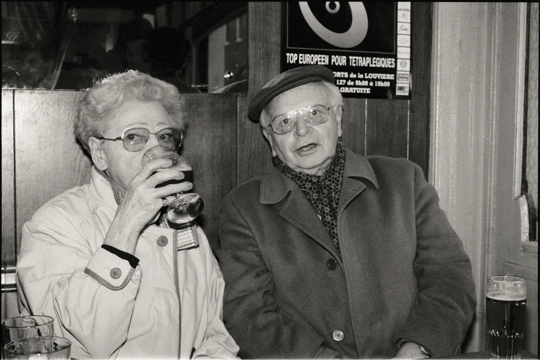 black and white pograph of man and woman sitting at a table together