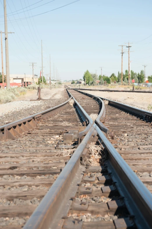 a person standing on a train track with power lines in the background