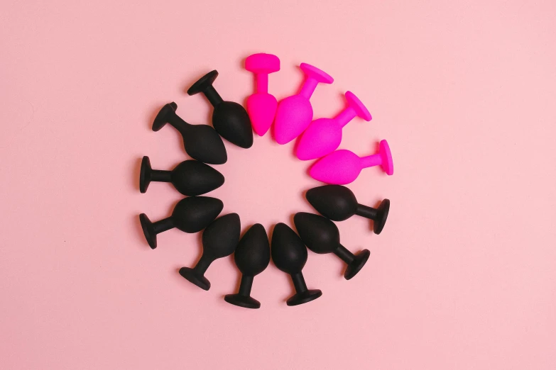 an assortment of black and pink objects sitting in a circular formation