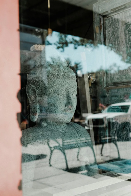 a small statue in the window of a small building