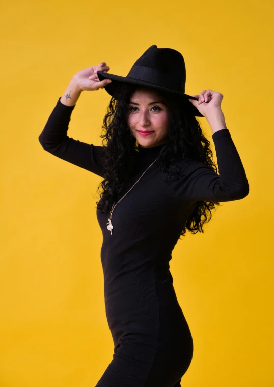a woman with long black hair and a black hat