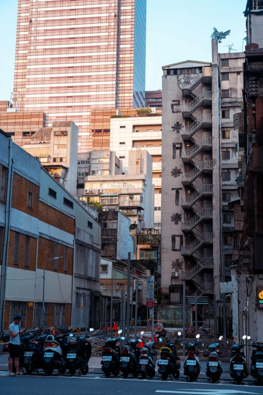 motorcycle taxi on city street with tall buildings