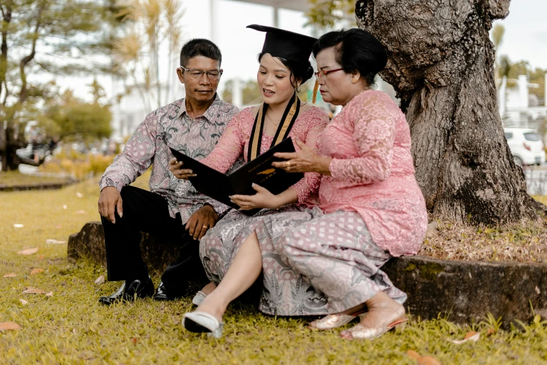 the graduates are in a park to congratulate each other