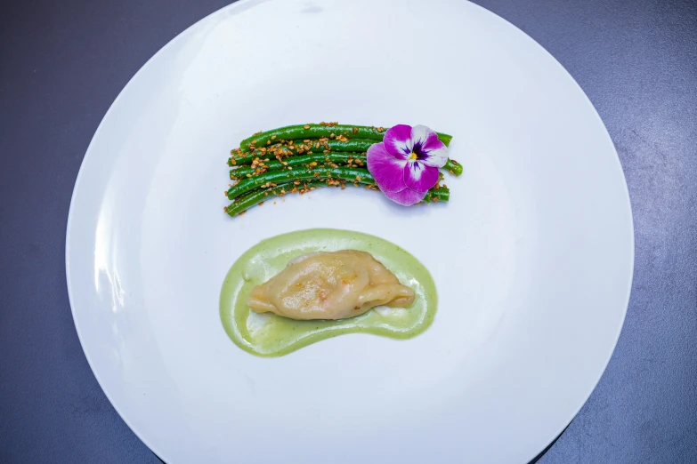 a plate with asparagus and some kind of sauce