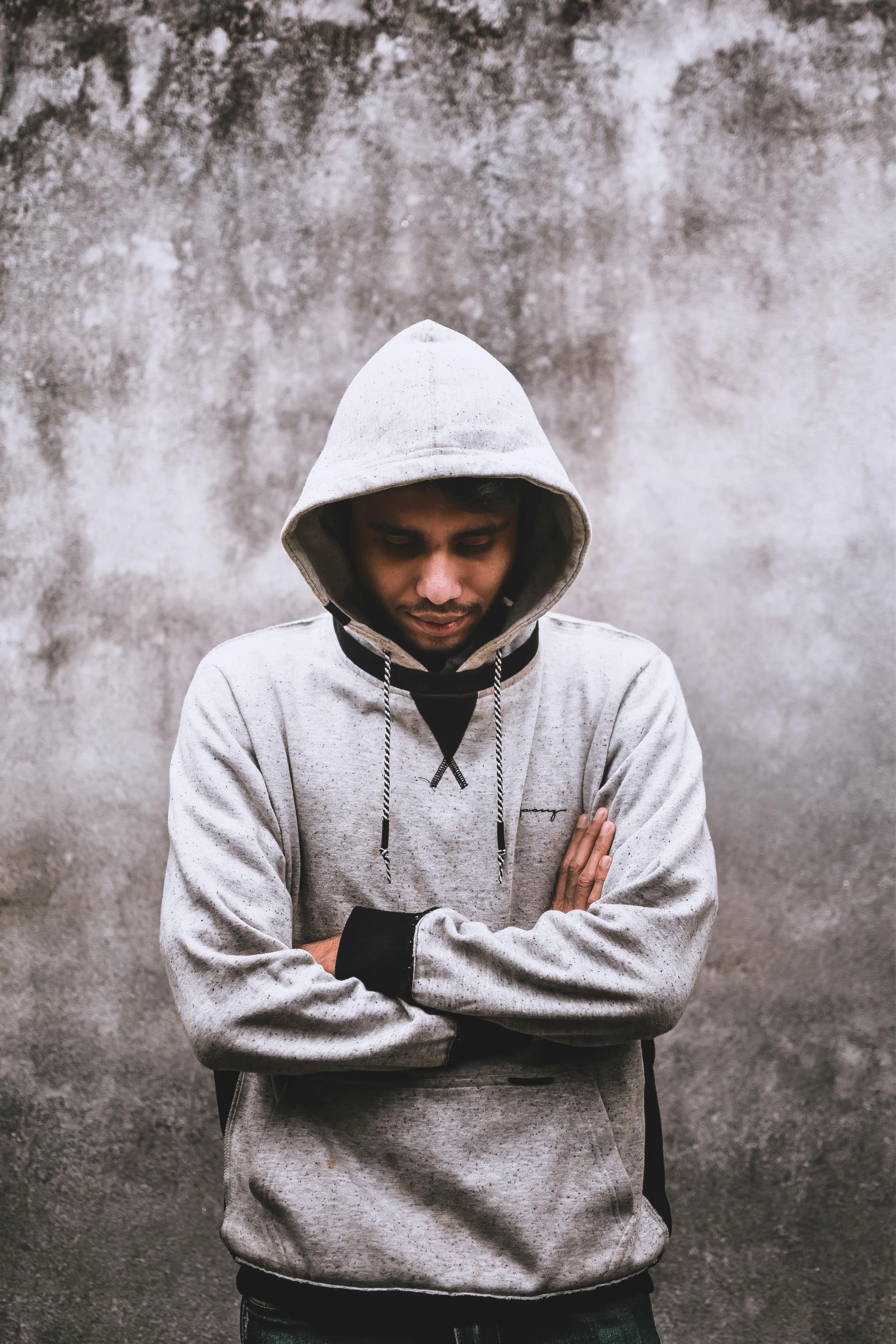 a man in a sweatshirt is looking pensive