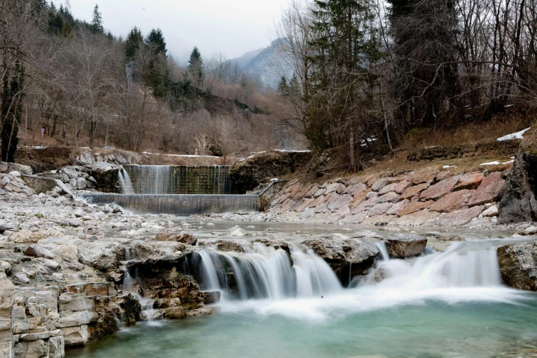 the waterfall at the bottom of a mountain side waterfall