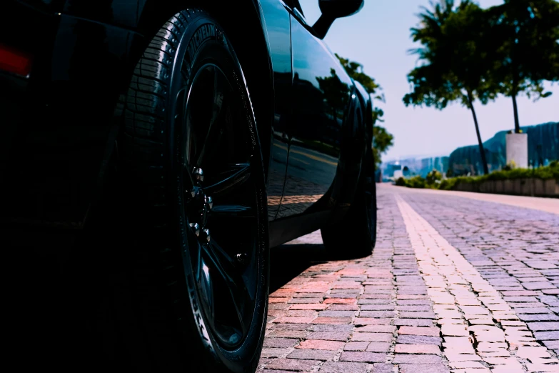 the tire of a sports car on the side of the road