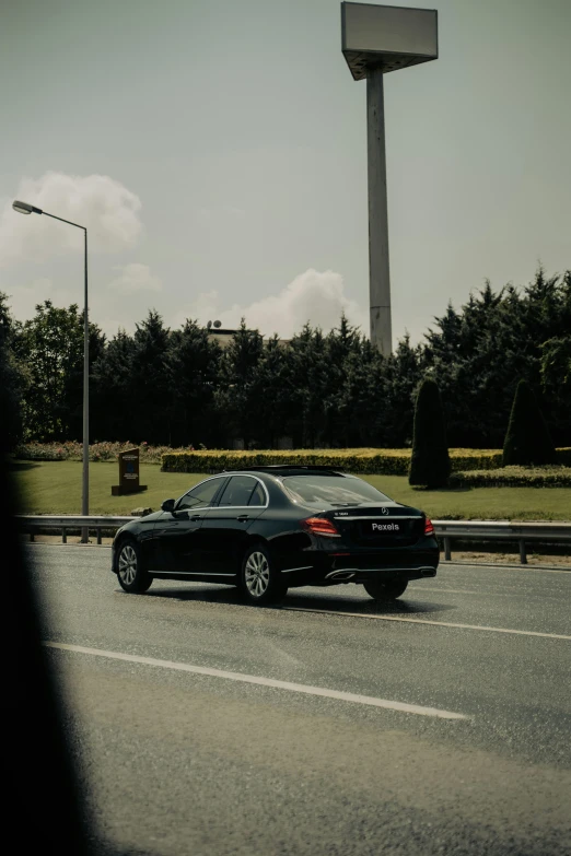 a car is parked in the street next to a large monument