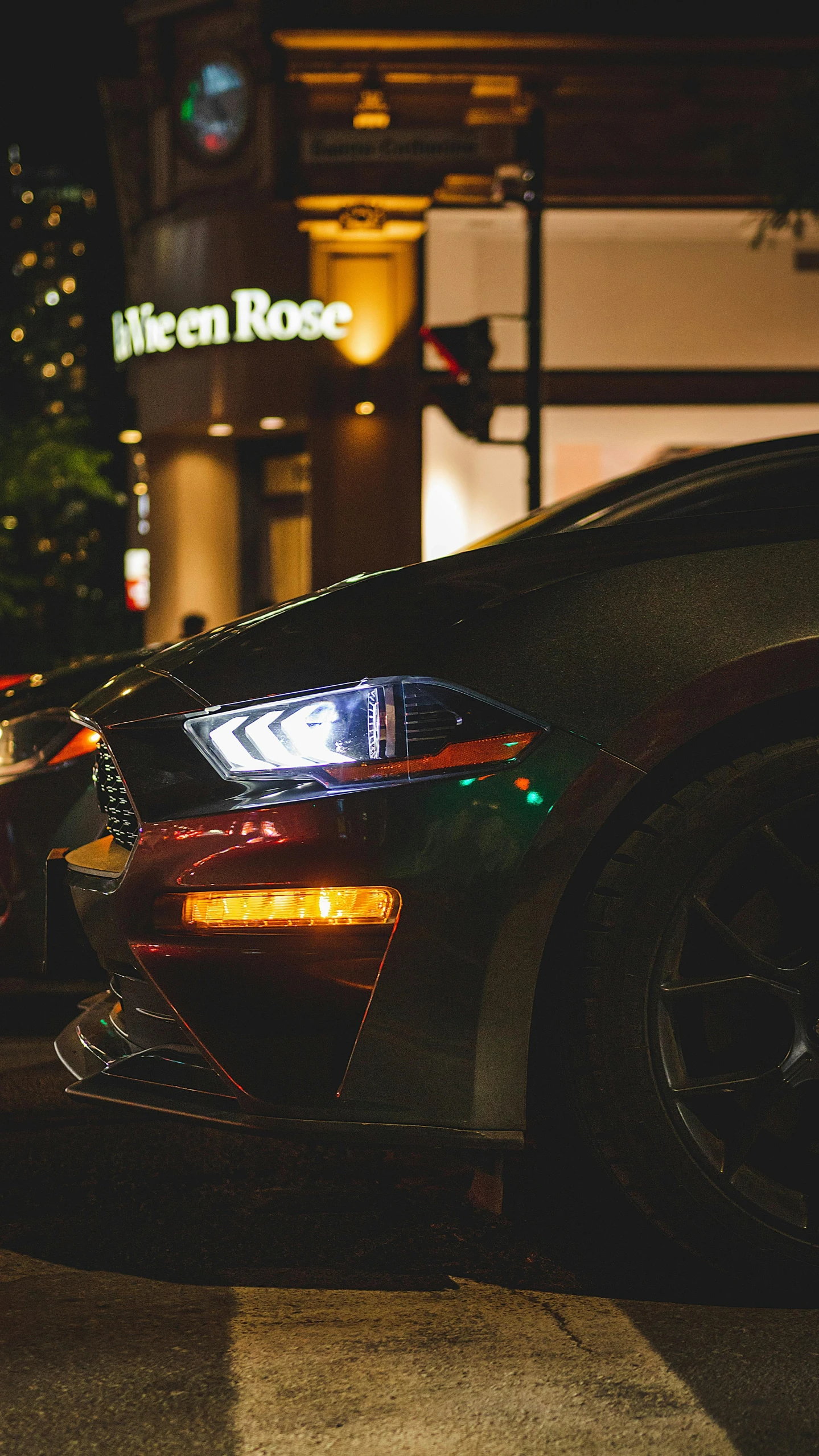 the dark sports car has it's lights on