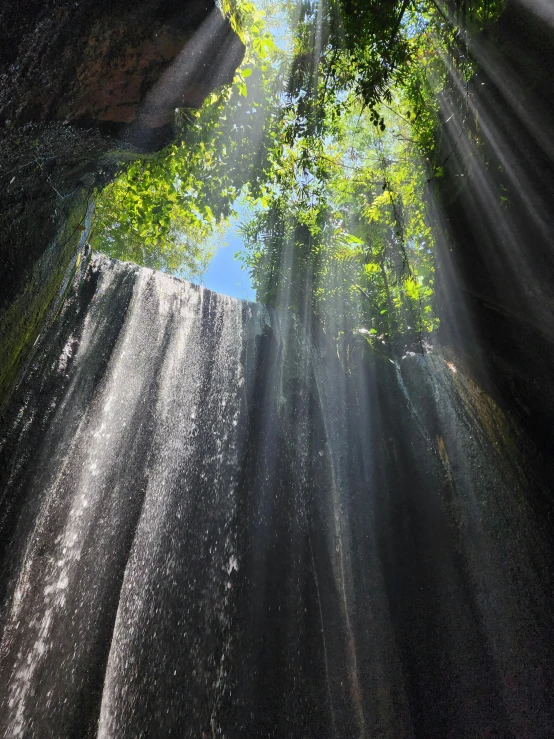 a large waterfall with many bright beams of sunlight