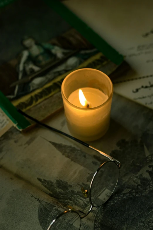 a candle that is sitting next to a book