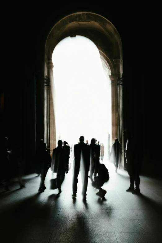 a group of people standing and sitting in a tunnel