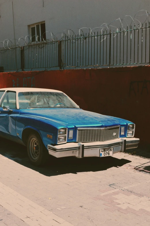 a car that is blue and white and parked