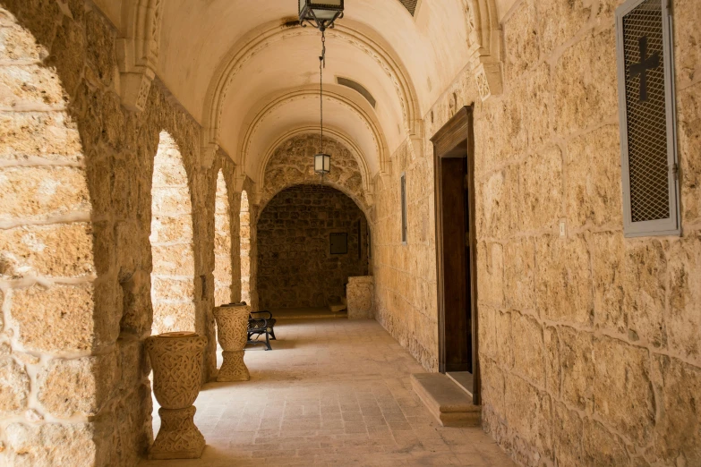 a very narrow corridor with lamps and brick walls