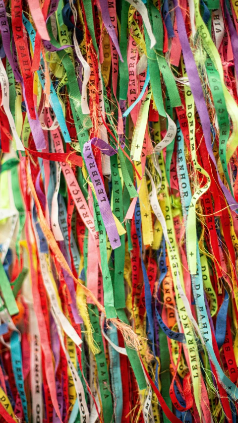 many different pieces of fabric hanging from the wall