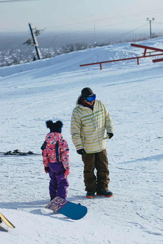 there is a snowboarder and another snow boarder on the ski slope